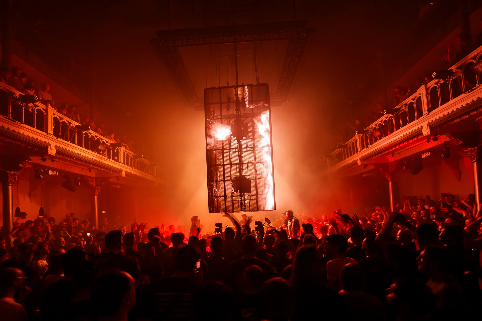 A packed Amsterdam Dance Event club room lit entirely in red